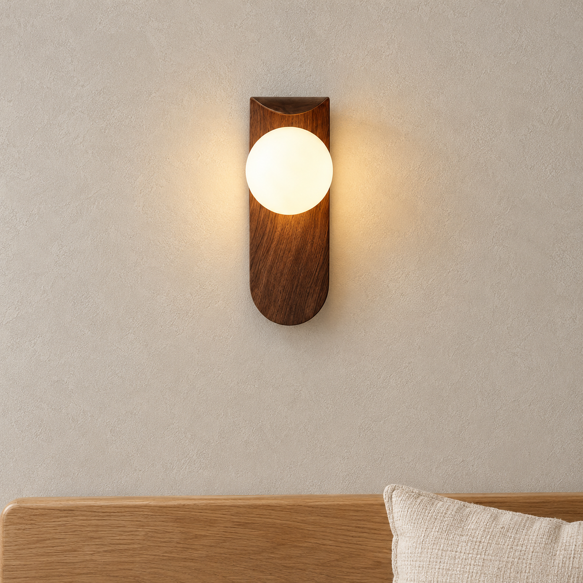 Ilvarne walnut wall lamp glowing warm above a dining bench in a daylit dining nook
