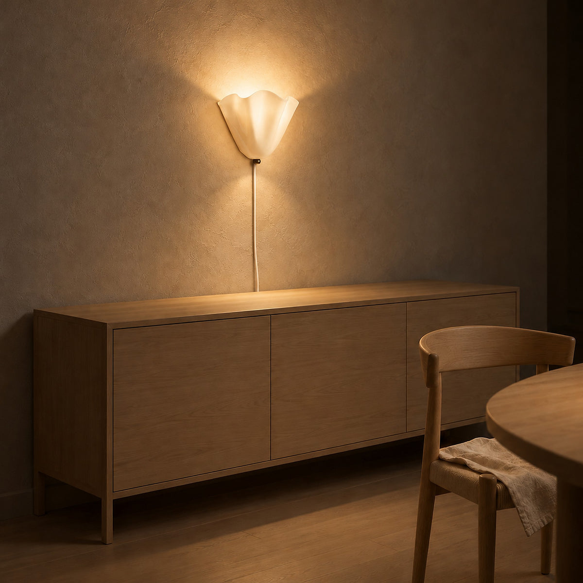 Lanorvi ivory glass wall light giving gentle evening light to a dining room