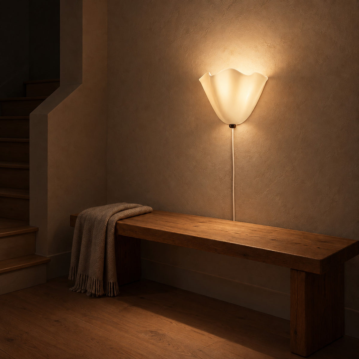 Lanorvi ivory glass wall sconce softly lighting a stair landing at night
