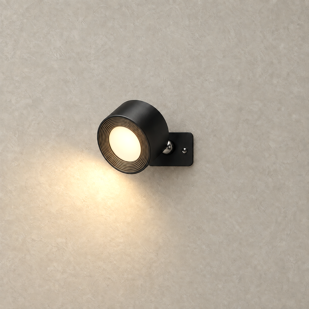 Lasirel black LED wall sconce lit and casting warm downward light