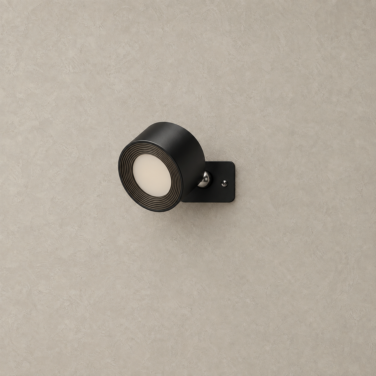 Lasirel black rechargeable wall sconce unlit on a plain plaster wall