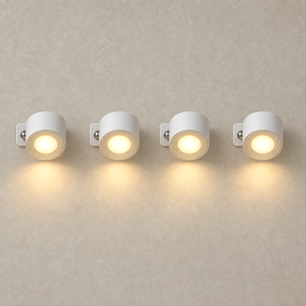 Lasirel white battery operated wall sconce set of 4 lit and grouped on a plain plate #color_white