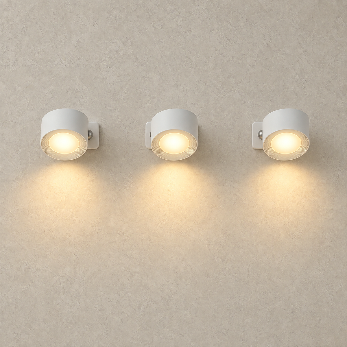 Lasirel white rechargeable wall sconce set of 3 lit in a row on a plain plate #color_white