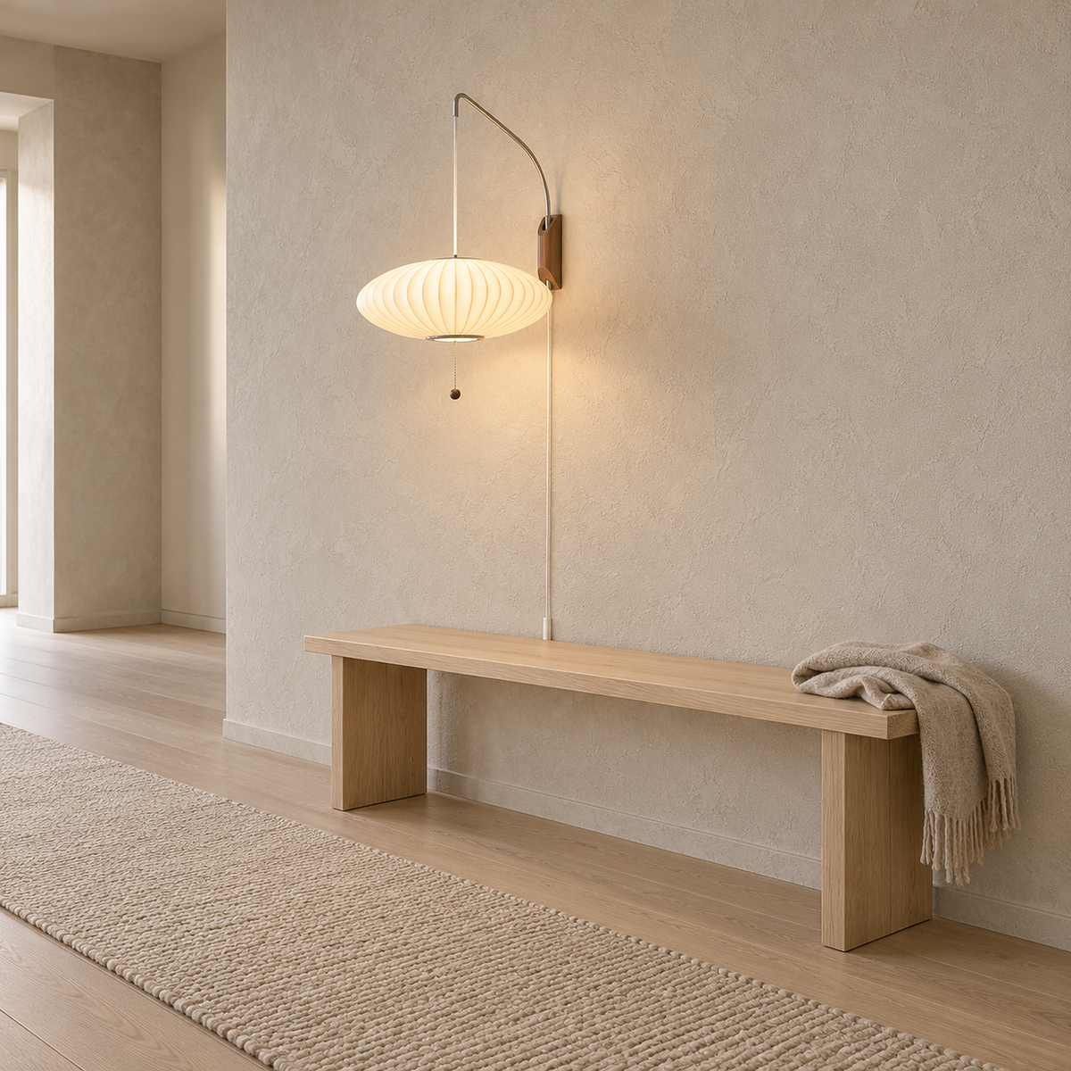 Lavomel chrome and walnut tone plug in wall lamp lit on an uninterrupted stretch of hallway plaster