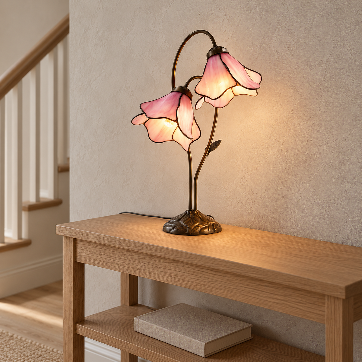 Linavor pink table lamp lit on an upstairs landing with its plug in cord trailing across the furniture
