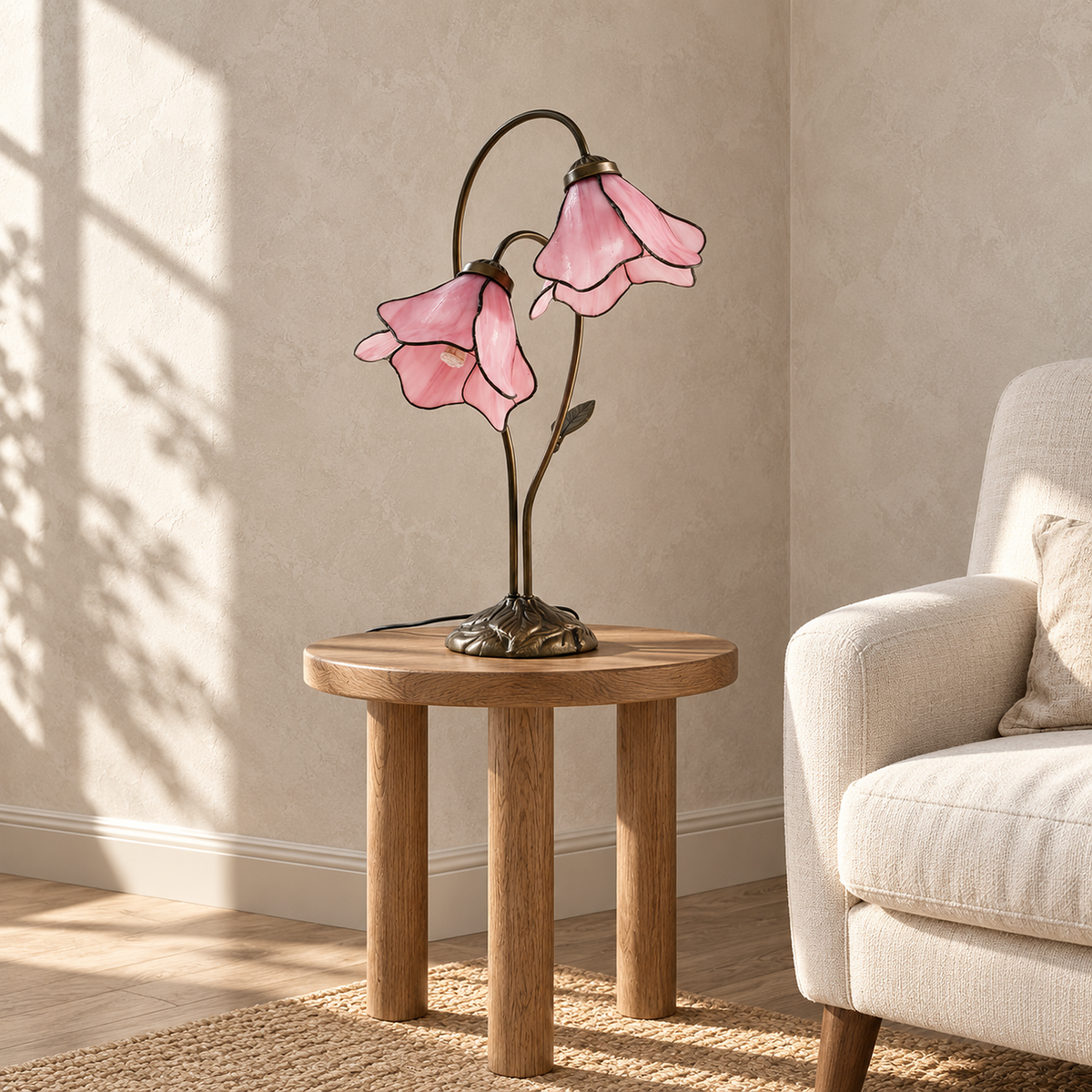 Linavor pink table lamp switched off, its glass flowers adding color to a sunlit sitting nook