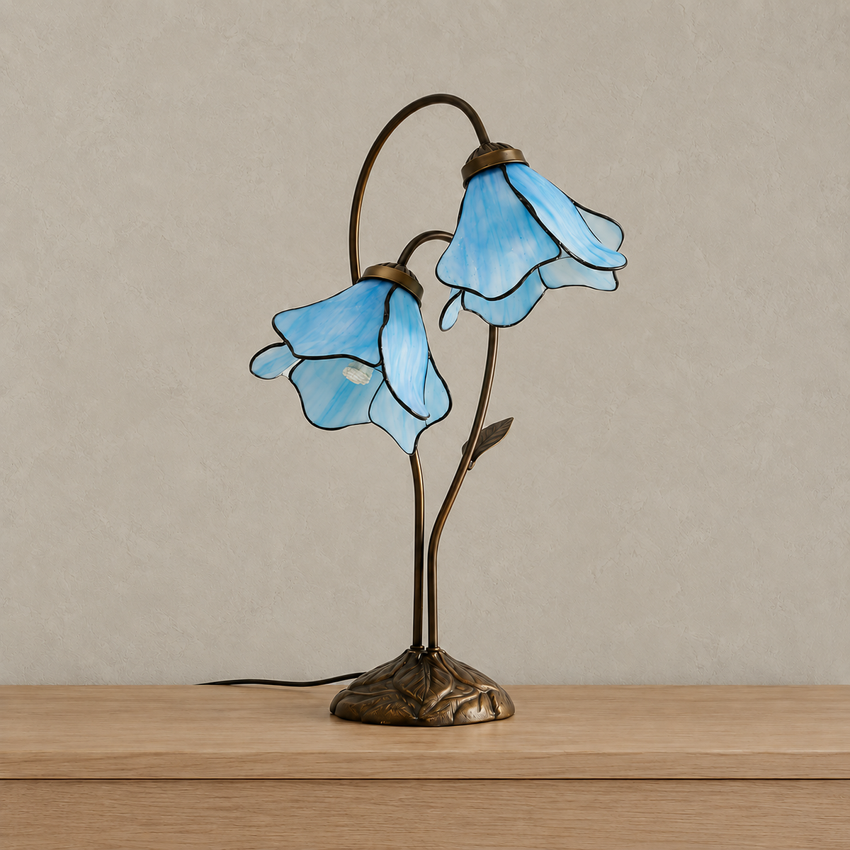 Linavor sky blue bedside lamp with unlit stained glass flower shades on a plain backdrop #color_sky blue