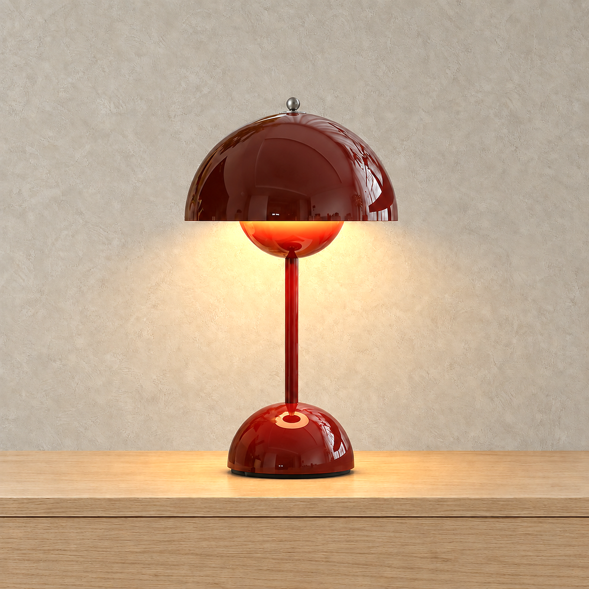 Linoveta red claret LED desk lamp giving a warm glow from under its rounded mushroom dome