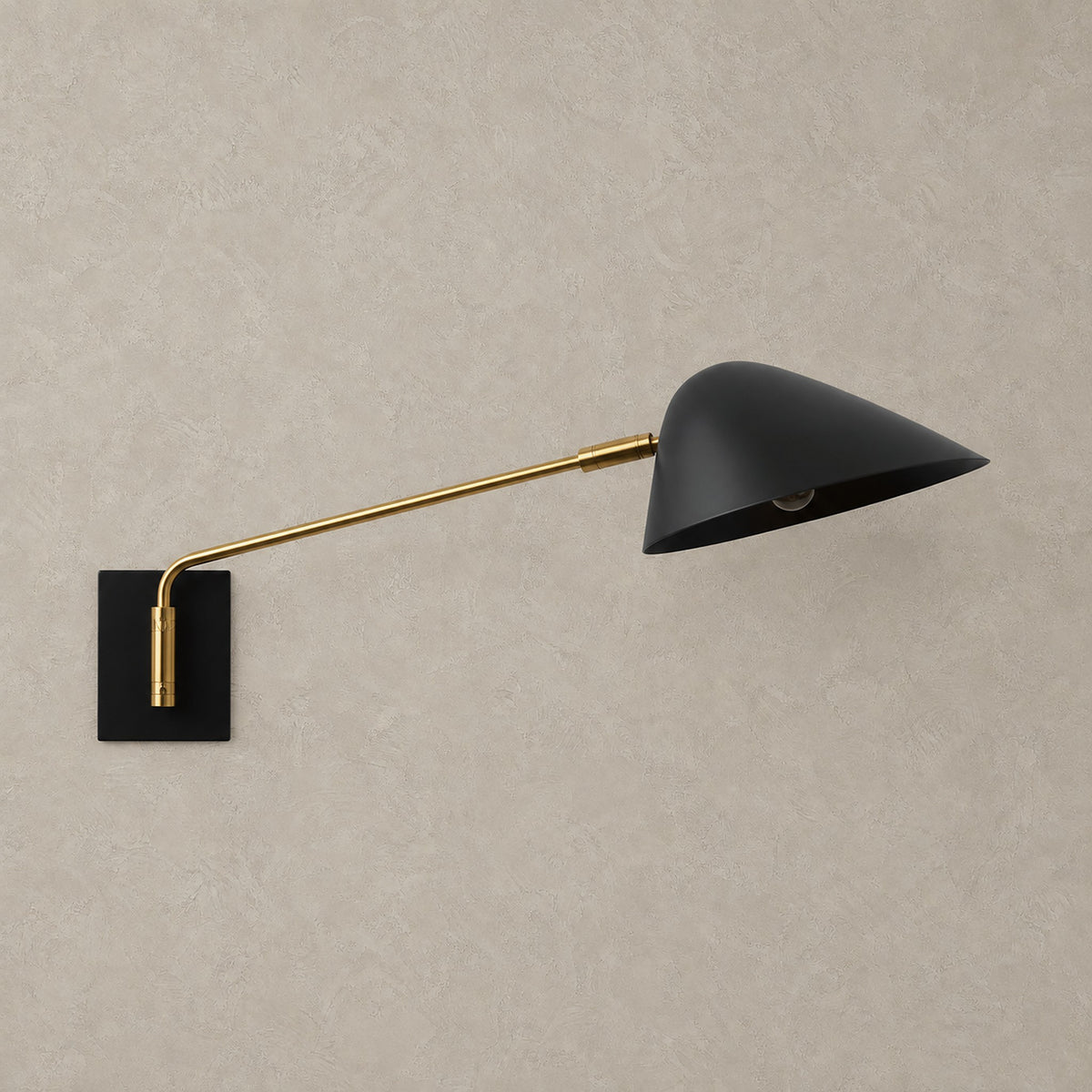Lirmena black hardwired led wall sconce with shade and plated finish, unlit against greige plaster
