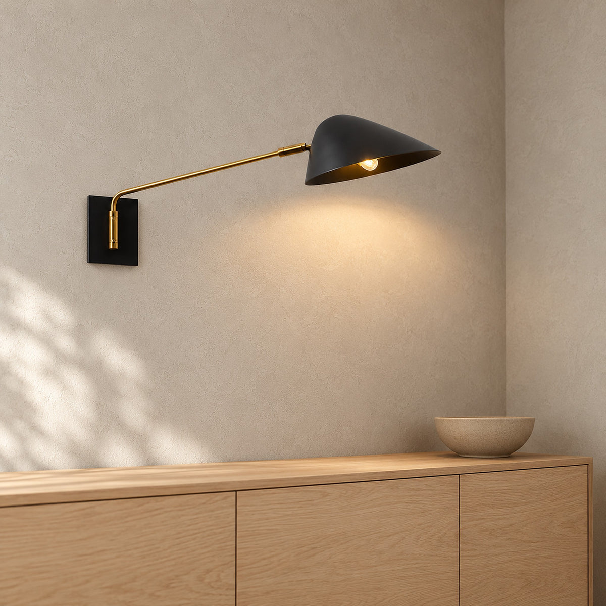 Lirmena black led wall sconce showing the lit underside of its open shade in a dining room