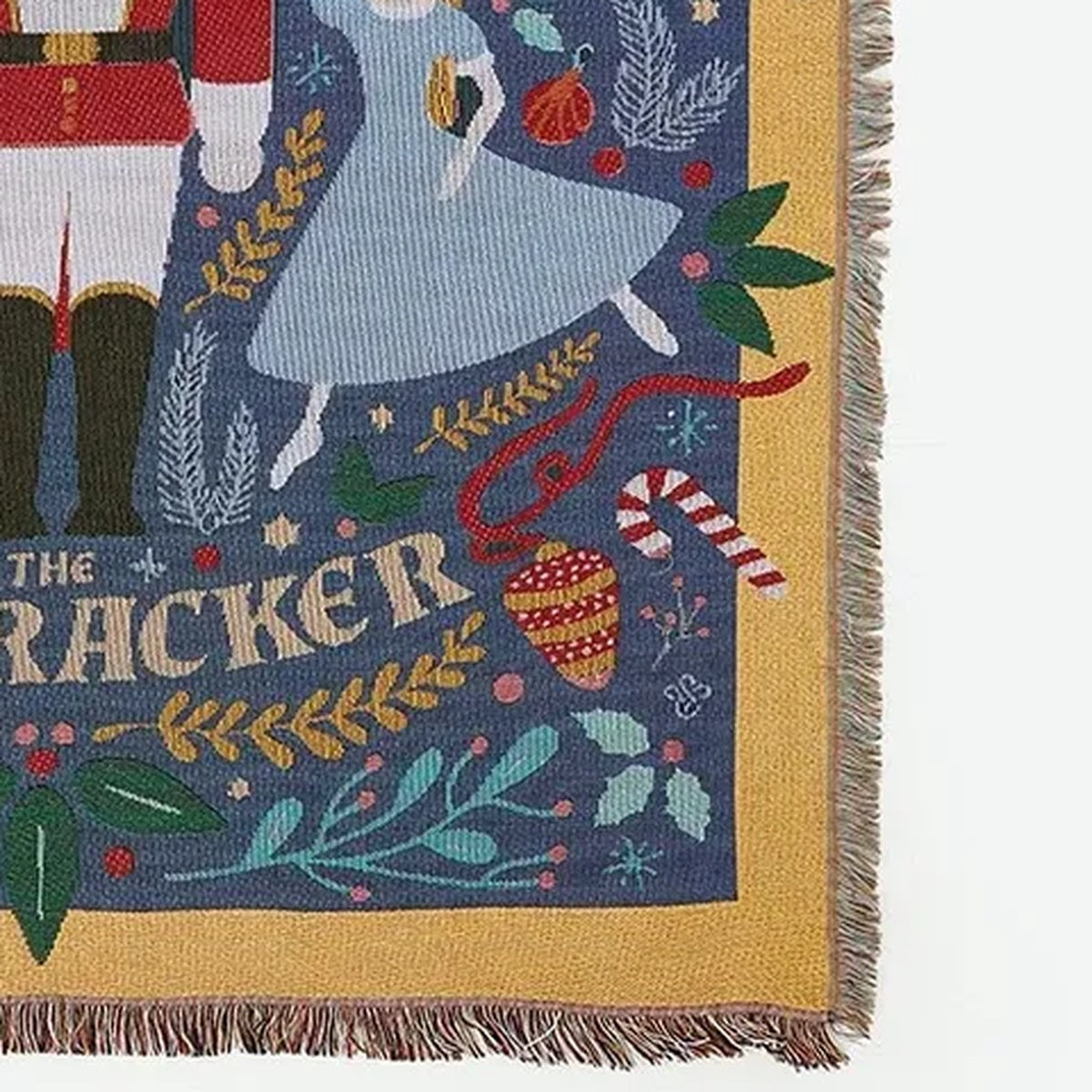 Lisorvan christmas cotton throw blanket on white, showing a patterned corner with a gold border and fringed edges.