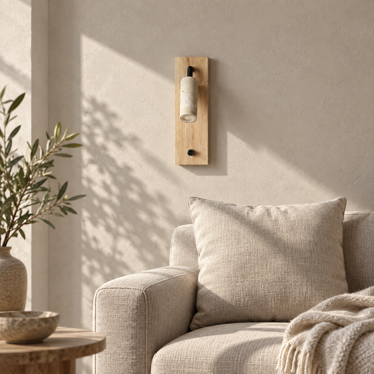 Lomarel wood LED wall sconce switched off above an oatmeal sofa cushion in daylight