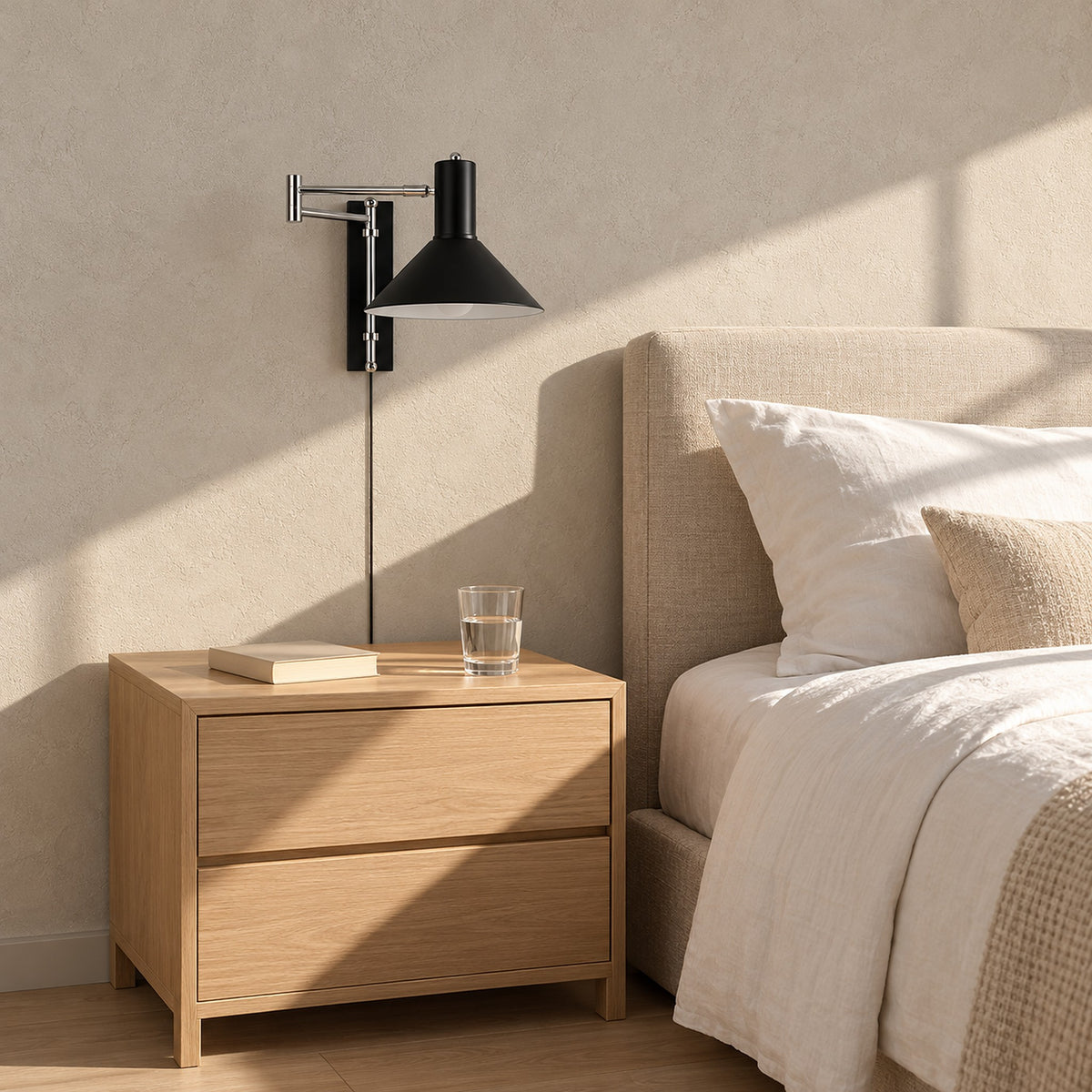 Lomaresi black bedside wall light with the folding arm tucked in beside a guest bed