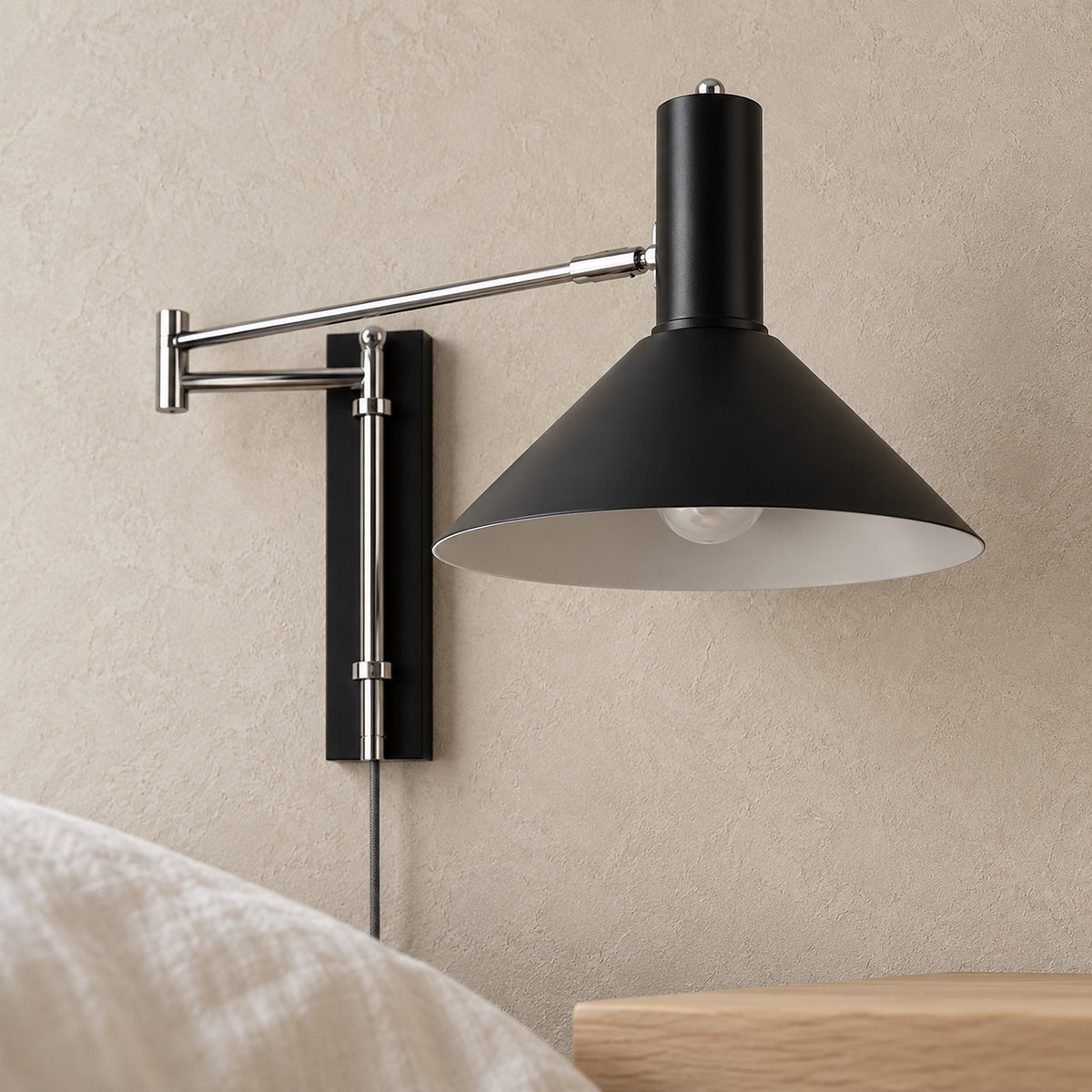 Lomaresi black metal wall lamp, close view of the shade and its open underside