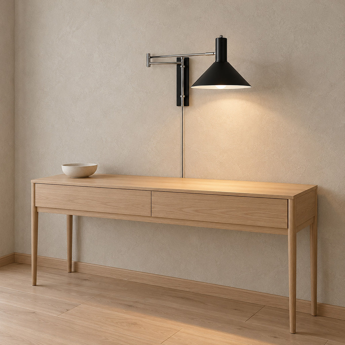 Lomaresi black plug in wall lamp lit in an entry hall with its power cord running down the wall