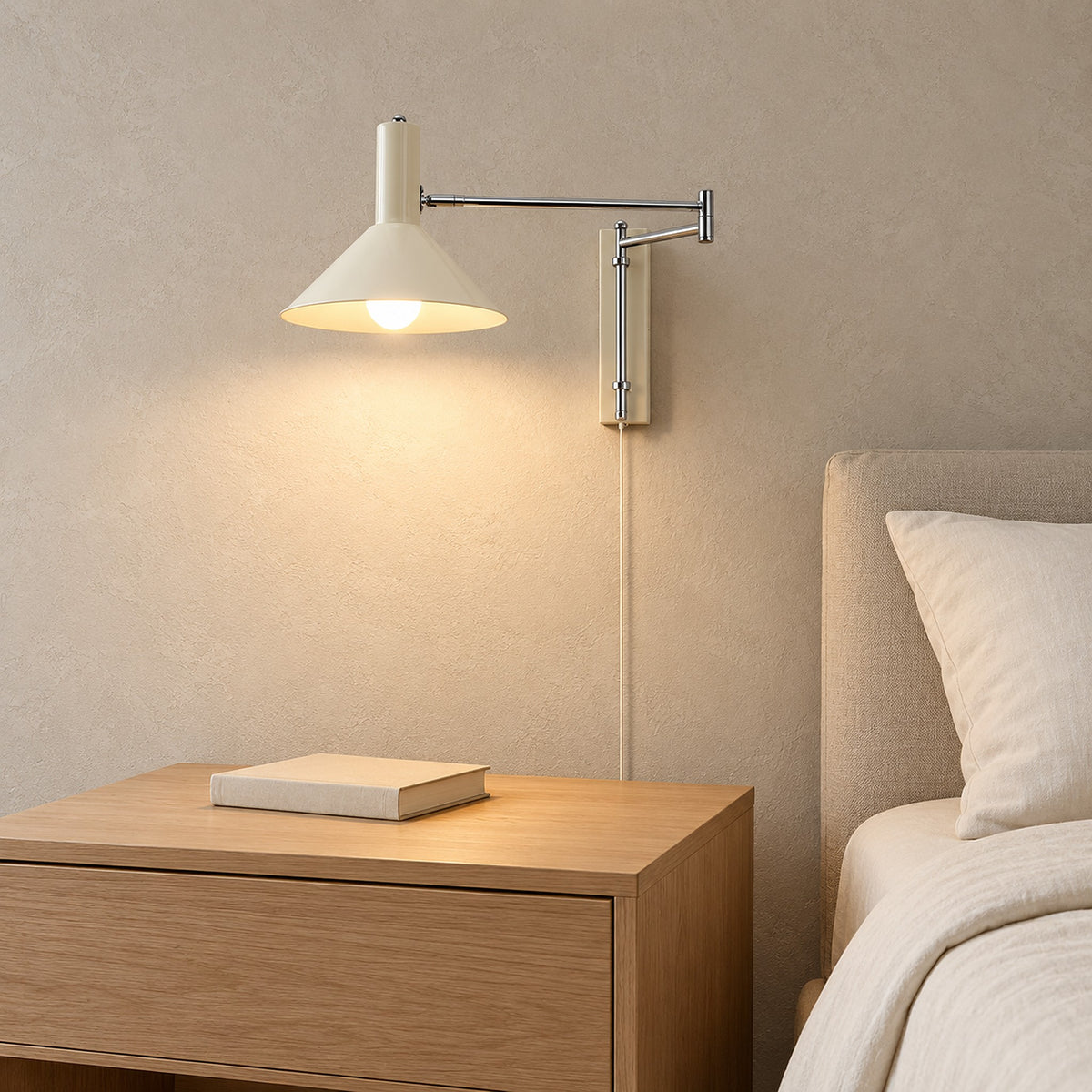 Lomaresi white bedside wall light glowing beside the bed in a guest sleeping alcove #color_white