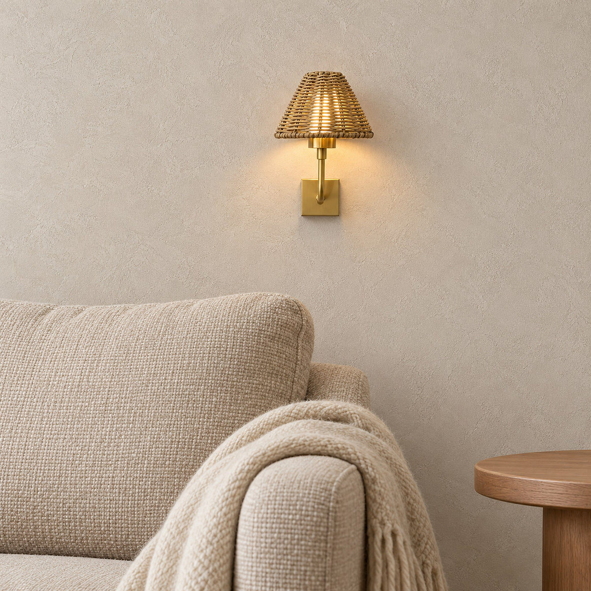Lomarvi gold battery operated wall sconce glowing beside an armchair in a reading alcove