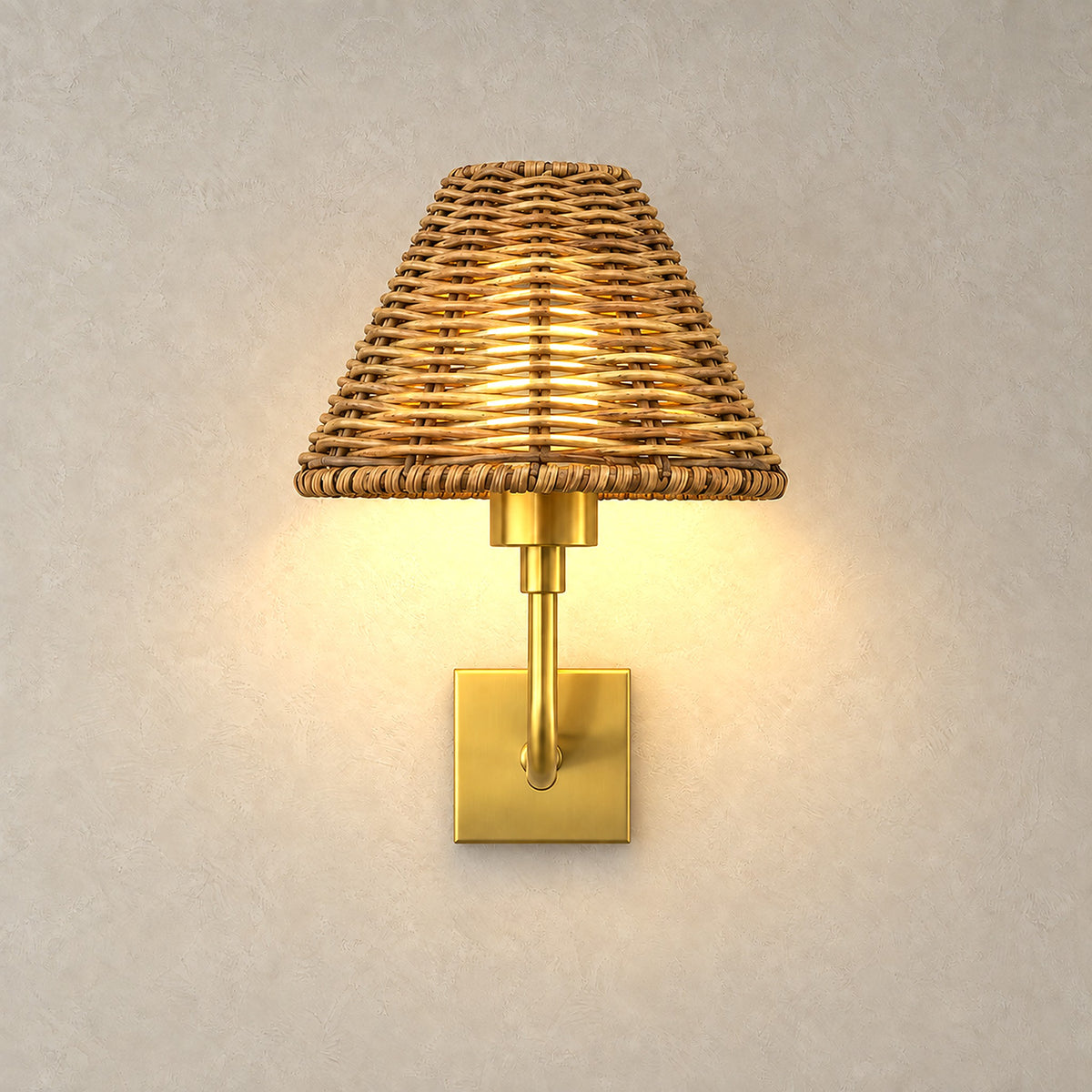 Lomarvi gold LED wall sconce switched on, warm light glowing through its cone shaped woven shade