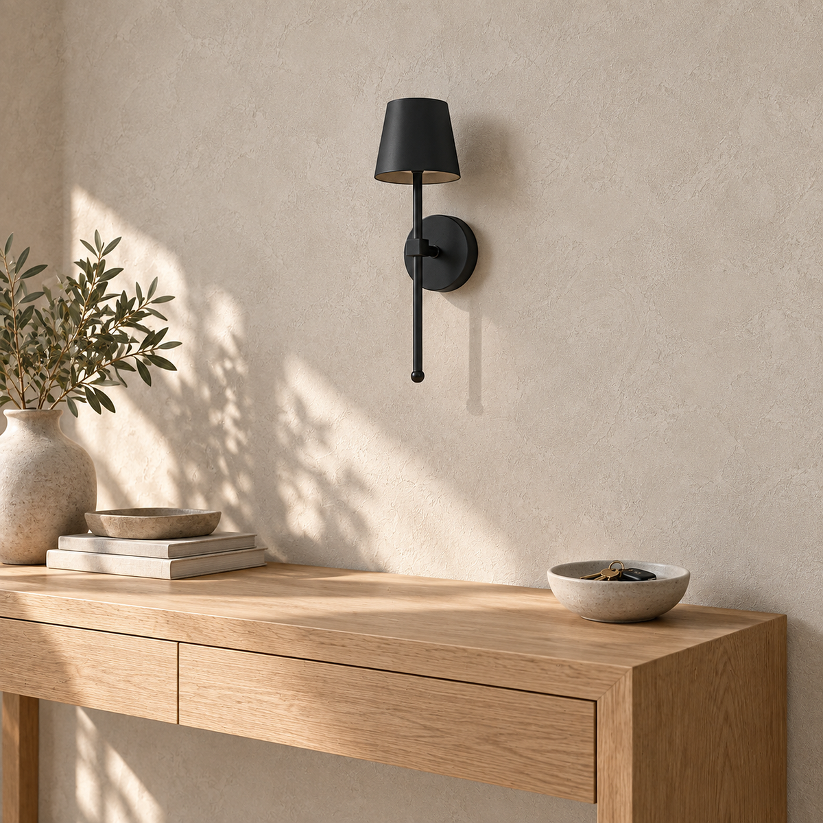 Loranno black battery operated wall sconce unlit above a sunlit entry console