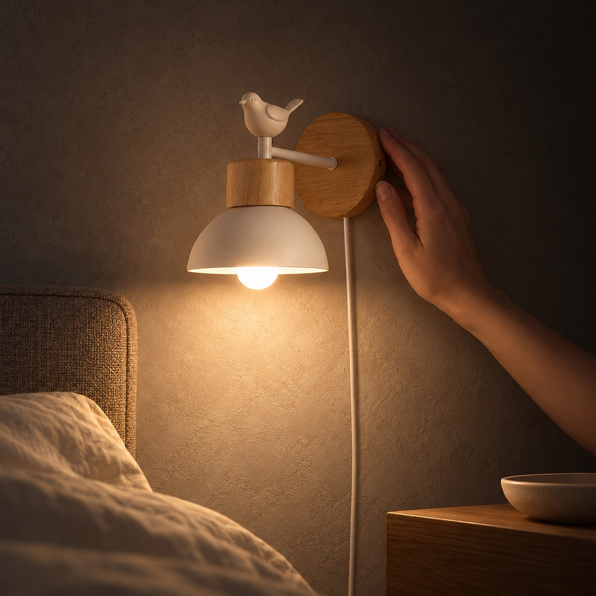 Lorsenta white bedside wall light casting a pool of light by the bed at night