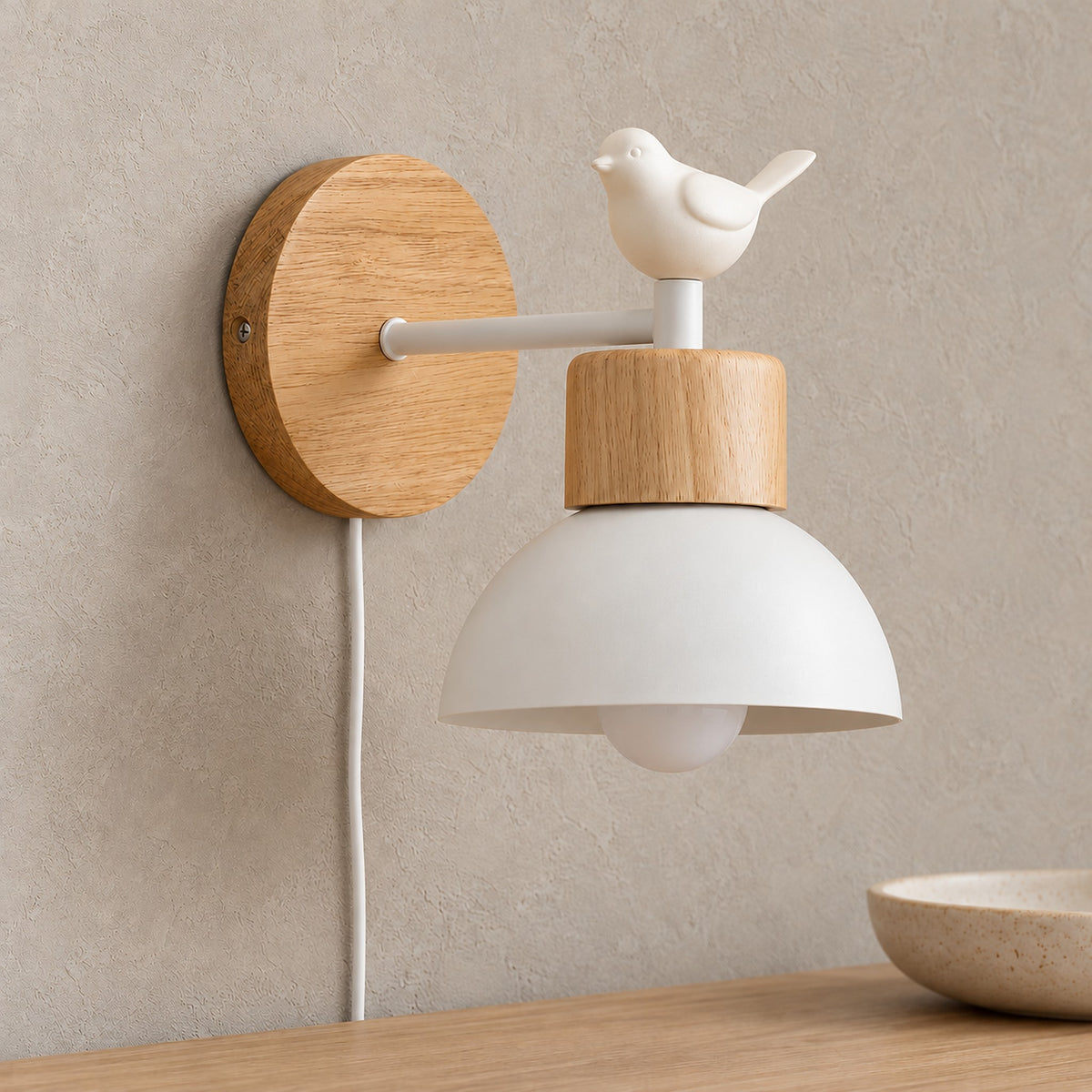 Lorsenta white wall sconce close up of the bird ornament and natural wood grain