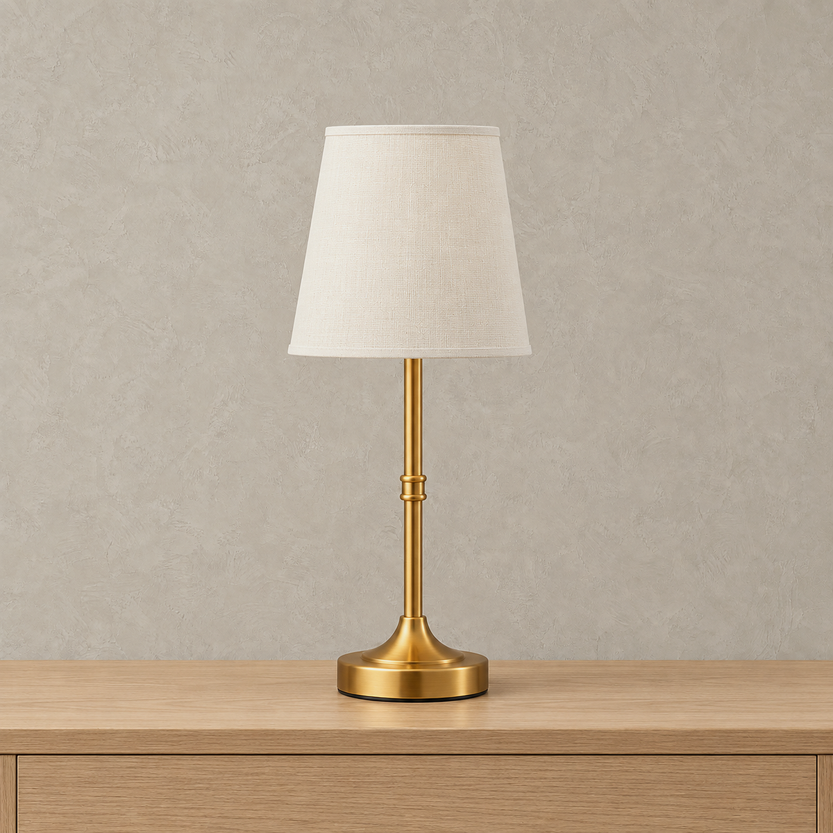 Lorvesa gold rechargeable table lamp with a white shade and round base, switched off on a plain backdrop
