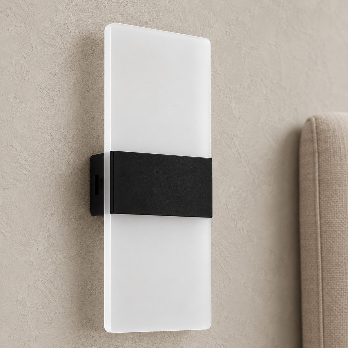 Melavor black rechargeable wall sconce in close detail showing the panel edge and plain middle band