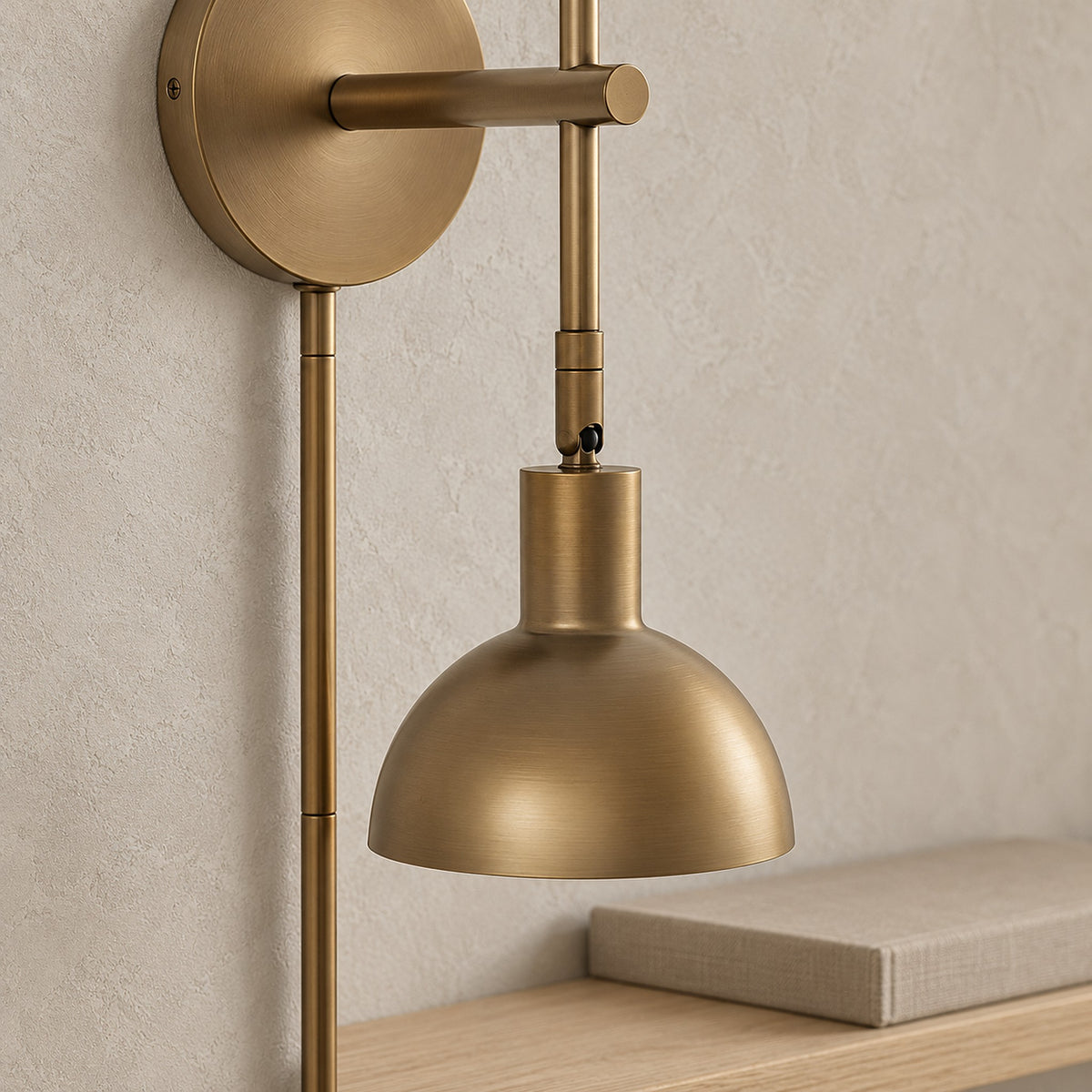 Melcasi led wall sconce in a close view of the antique brass colored metal shade and joint in daylight