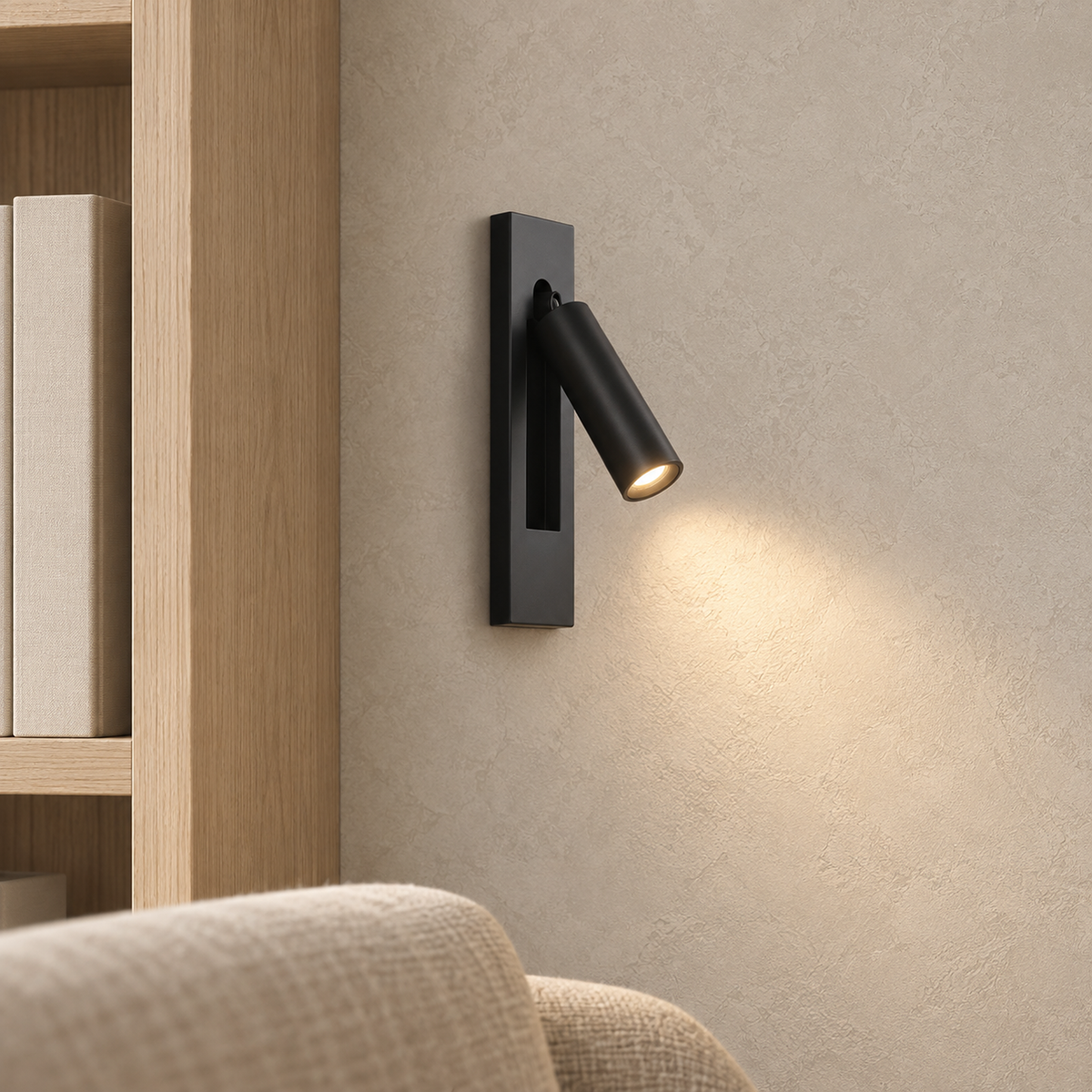 Menaliro black LED wall sconce mounted in a library alcove, showing its installed rectangular plate