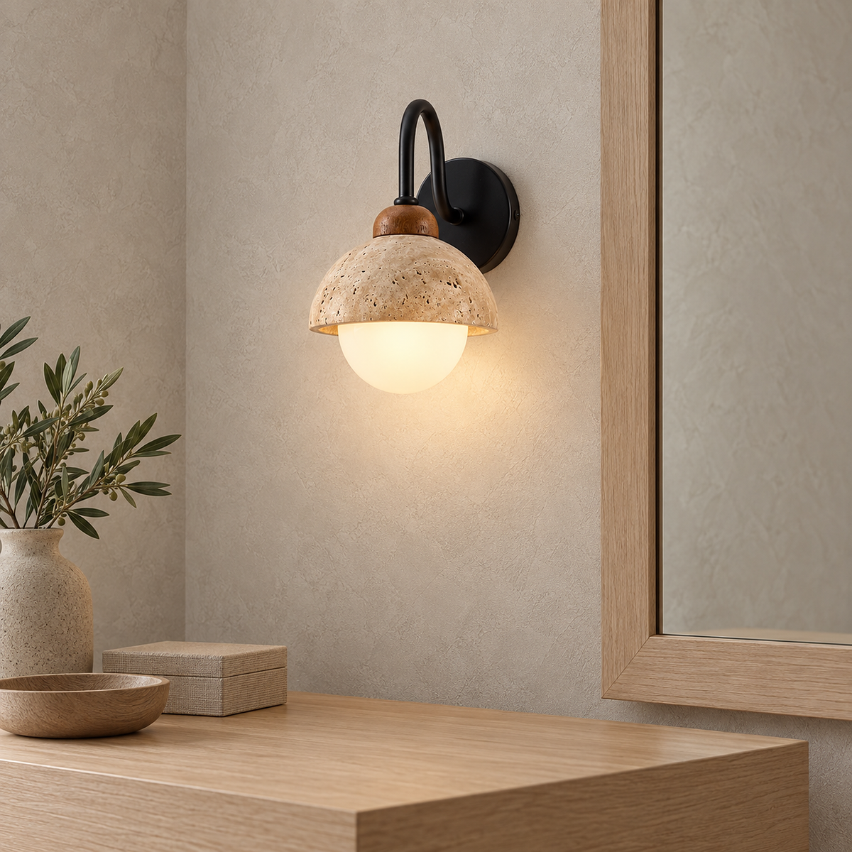 Meratilo yellow travertine and black hardwired wall sconce lit with white glass globe beneath the stone rim