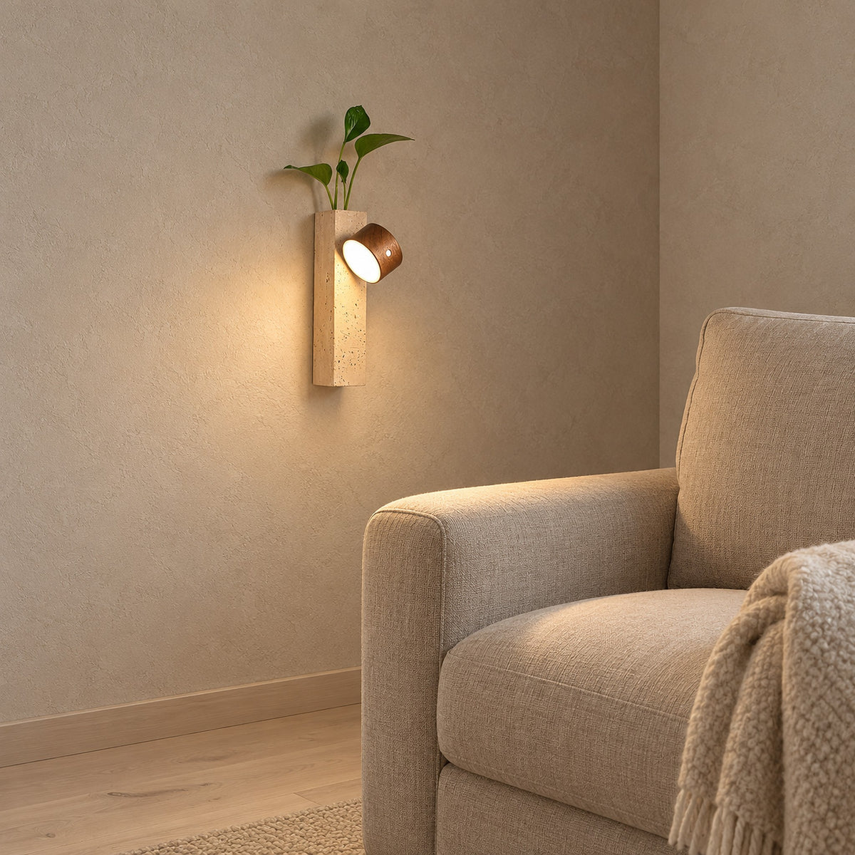 Mernavo dark wood and yellow travertine cordless wall lamp glowing close beside a living room armchair