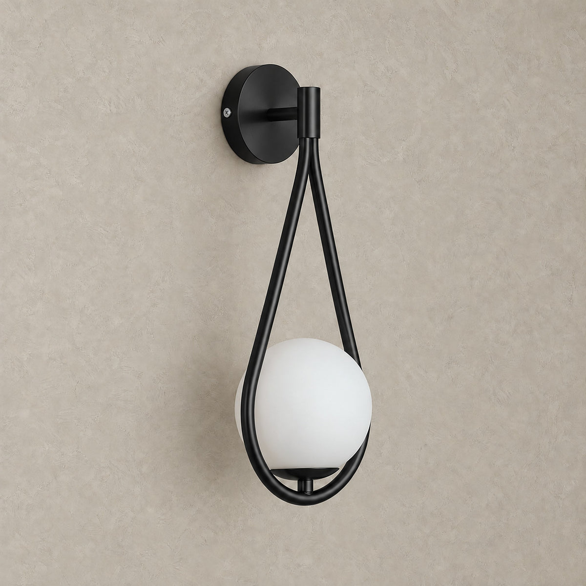 Mesaril black wall sconce shown unlit, black painted iron body and glass shade #color_black