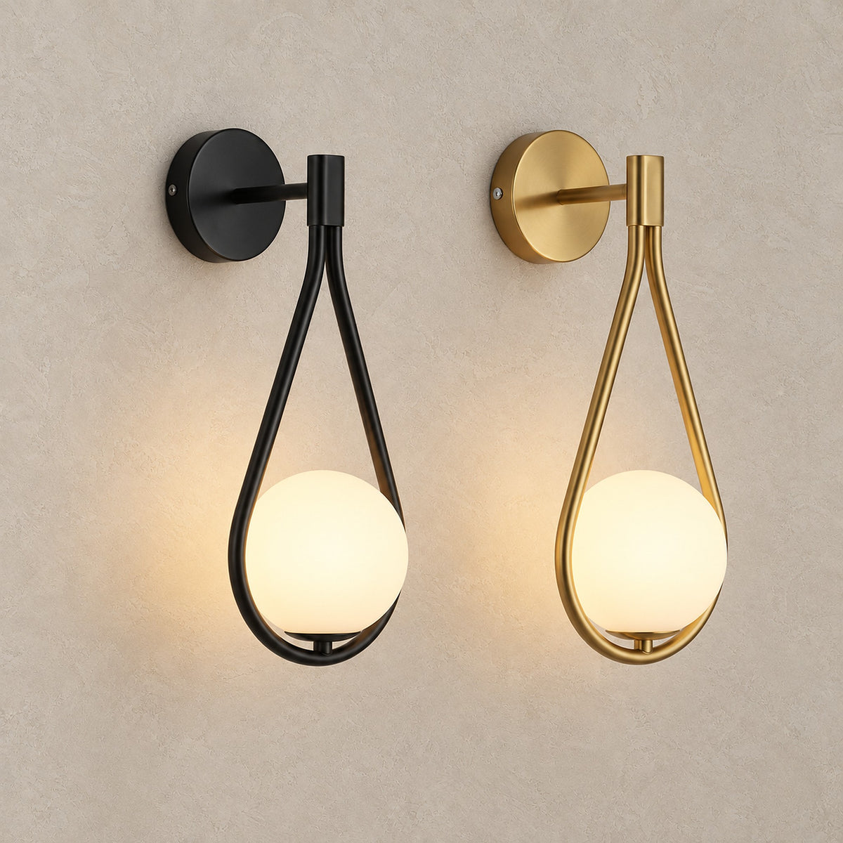 Mesaril gold and black wall sconces lit side by side, showing both painted finishes