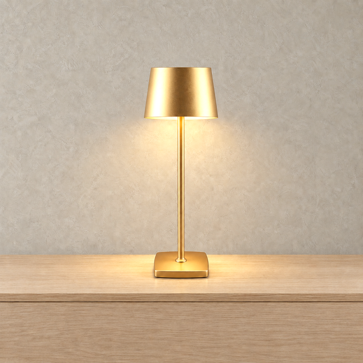 Mevolani gold bedside lamp glowing against a warm greige plaster wall