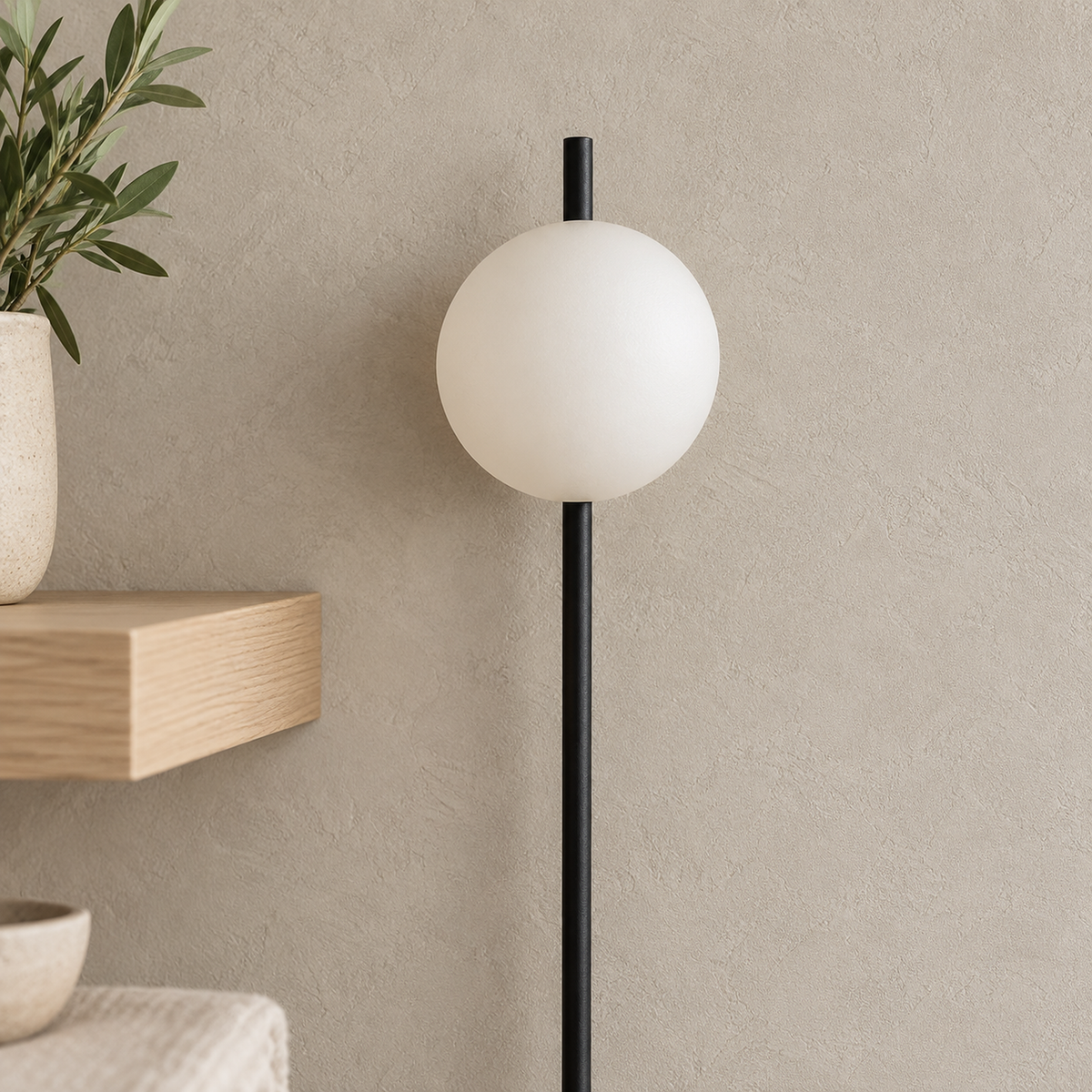 Milorsa black plug in wall sconce unlit, frosted glass globe shade on a long pole in a dining alcove