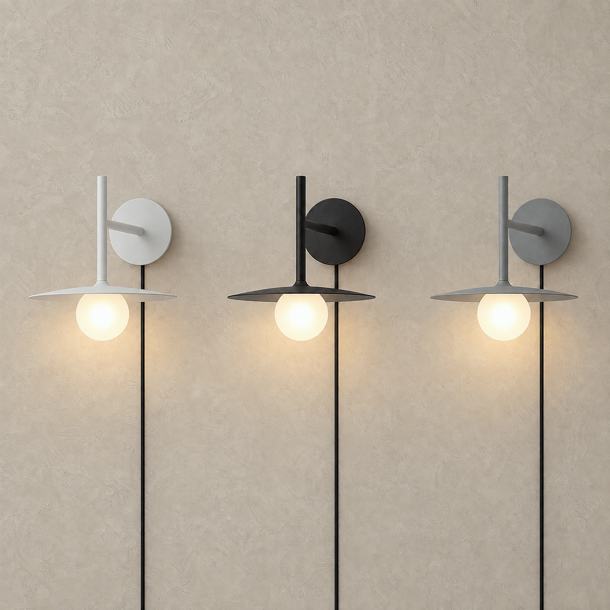 Milvaro white, black and gray wall sconces glowing side by side in one lit row