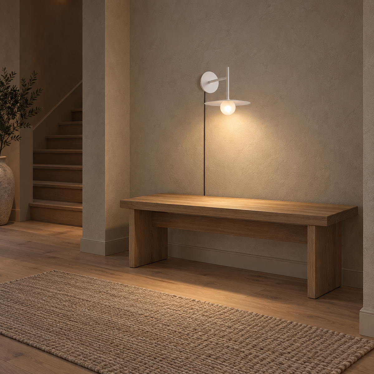Milvaro white plug in wall sconce lighting an empty entryway bench in midday light