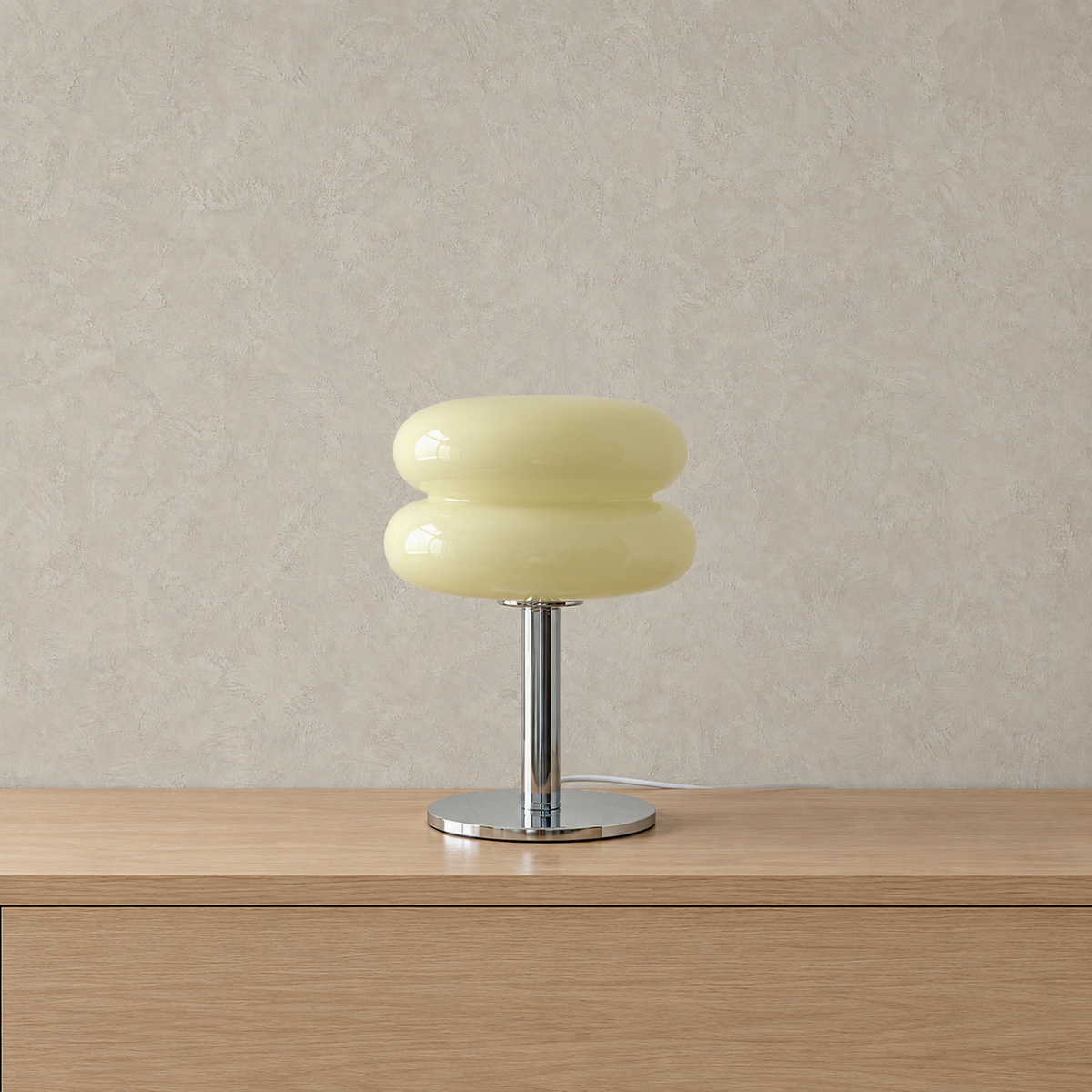 Misolen cream stained glass table lamp unlit against warm greige plaster
