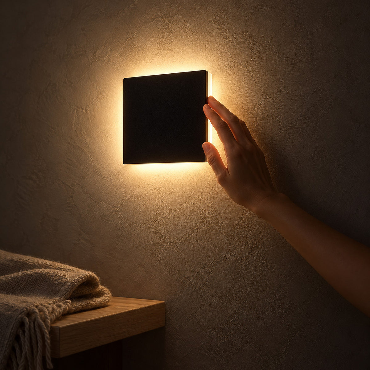 Mivorel black LED wall sconce with a square aluminum shade lighting an entryway plaster wall at night