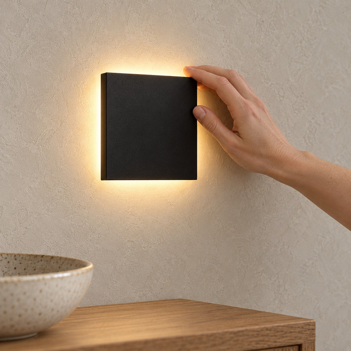 Mivorel black rechargeable wall sconce side profile showing the square shade lit on a dining room wall