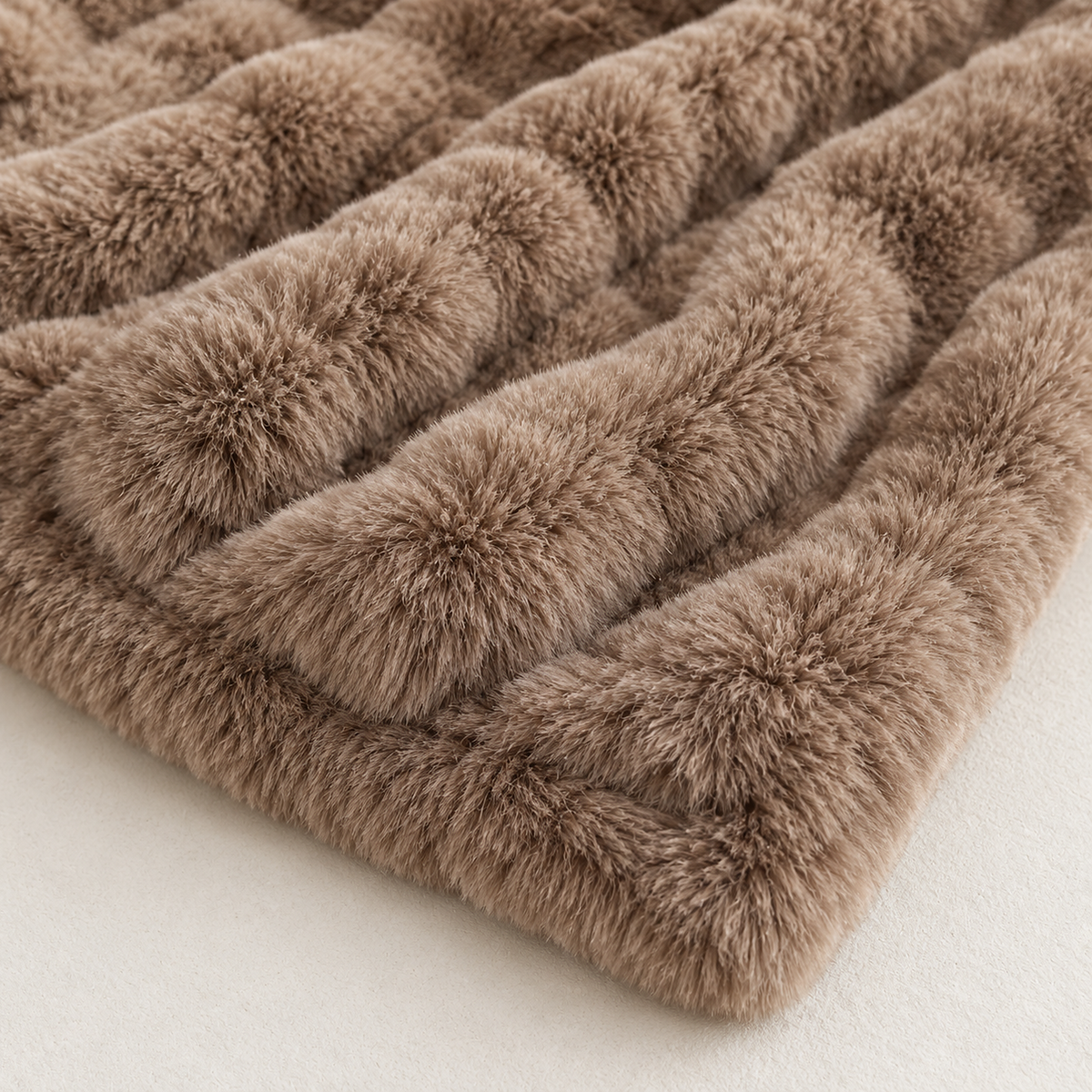 Molvari brown faux fur throw blanket close up of the rounded ridges and fibers in its geometric pattern