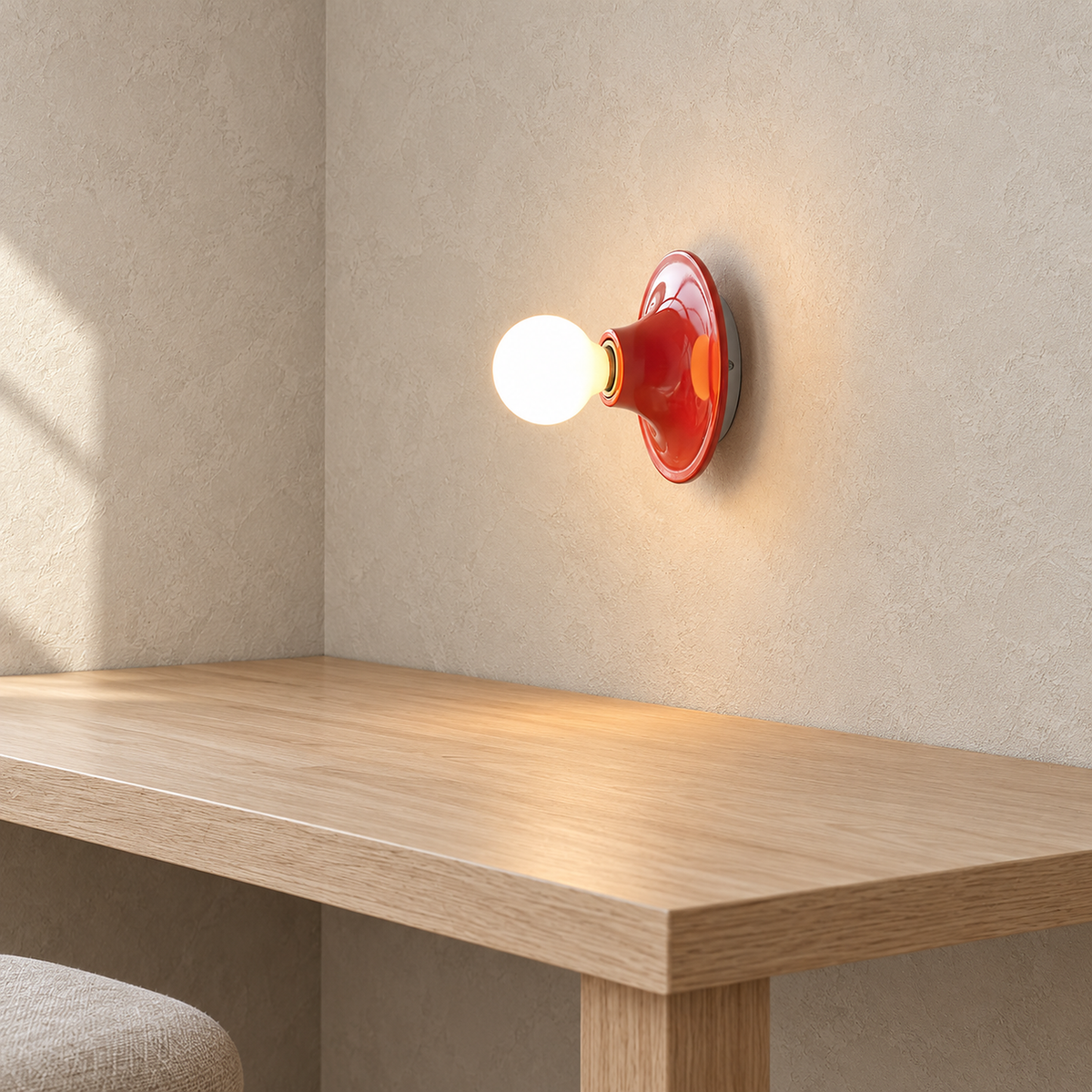 Monterla red wall lamp lit above a clear workbench corner in a craft room