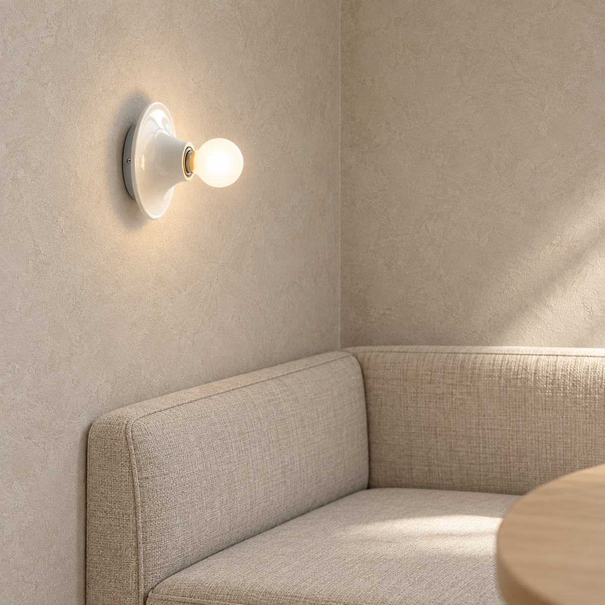 Monterla white wall light glowing over a bench in a sunlit breakfast nook #color_white