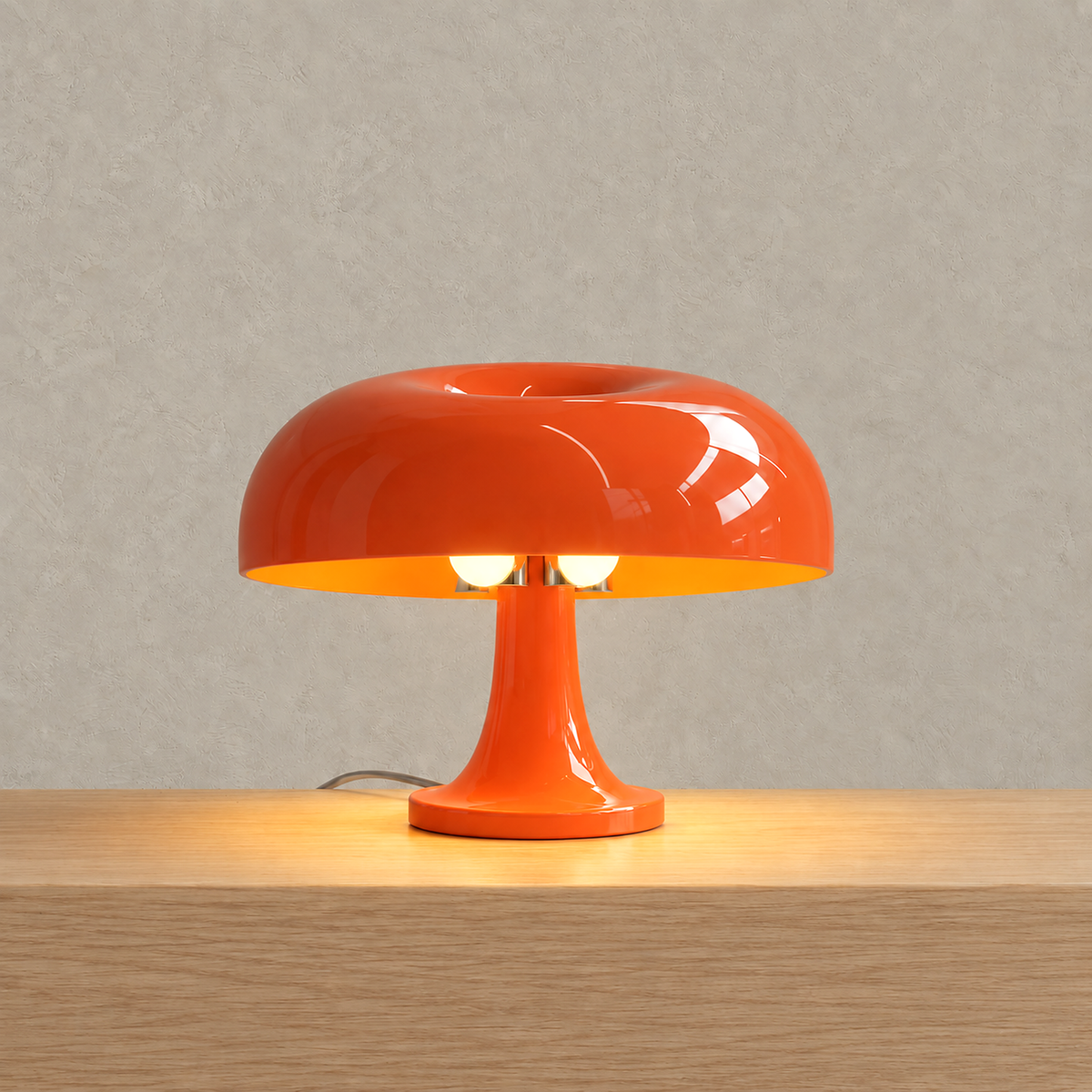Moranel orange table lamp lit with warm light glowing beneath its rounded mushroom shade