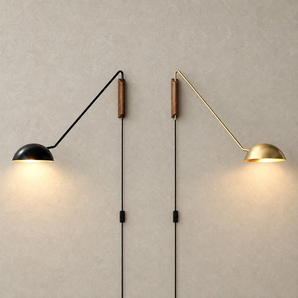 Nalesio black and gold plug in wall light pair lit side by side to compare both finishes