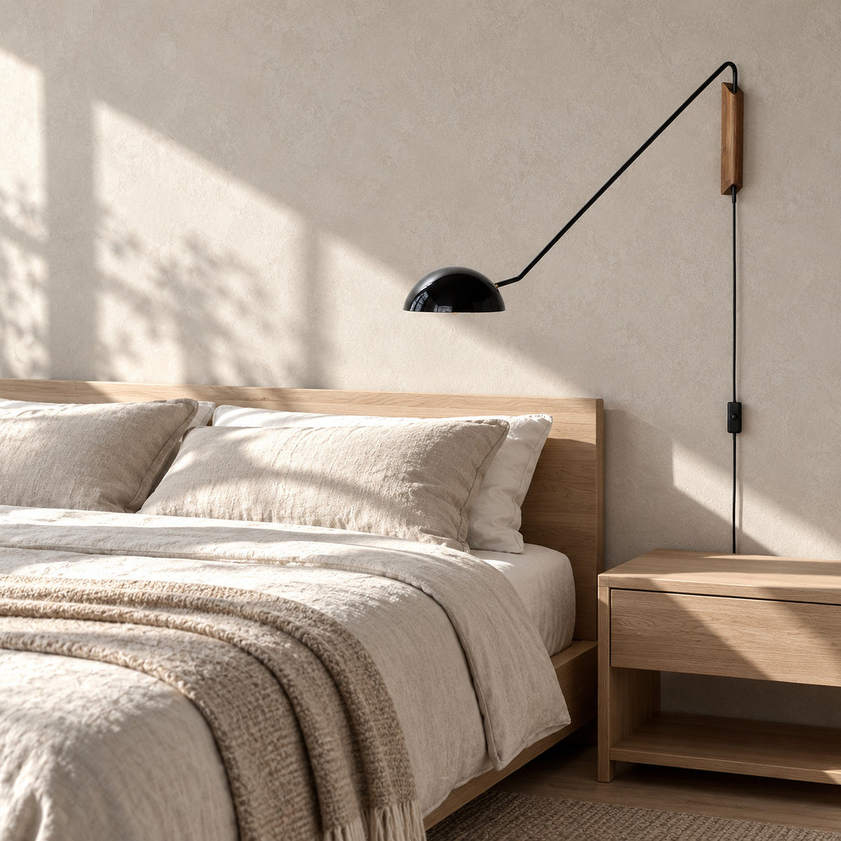Nalesio black wall lamp switched off on the wall of a sunny guest bedroom