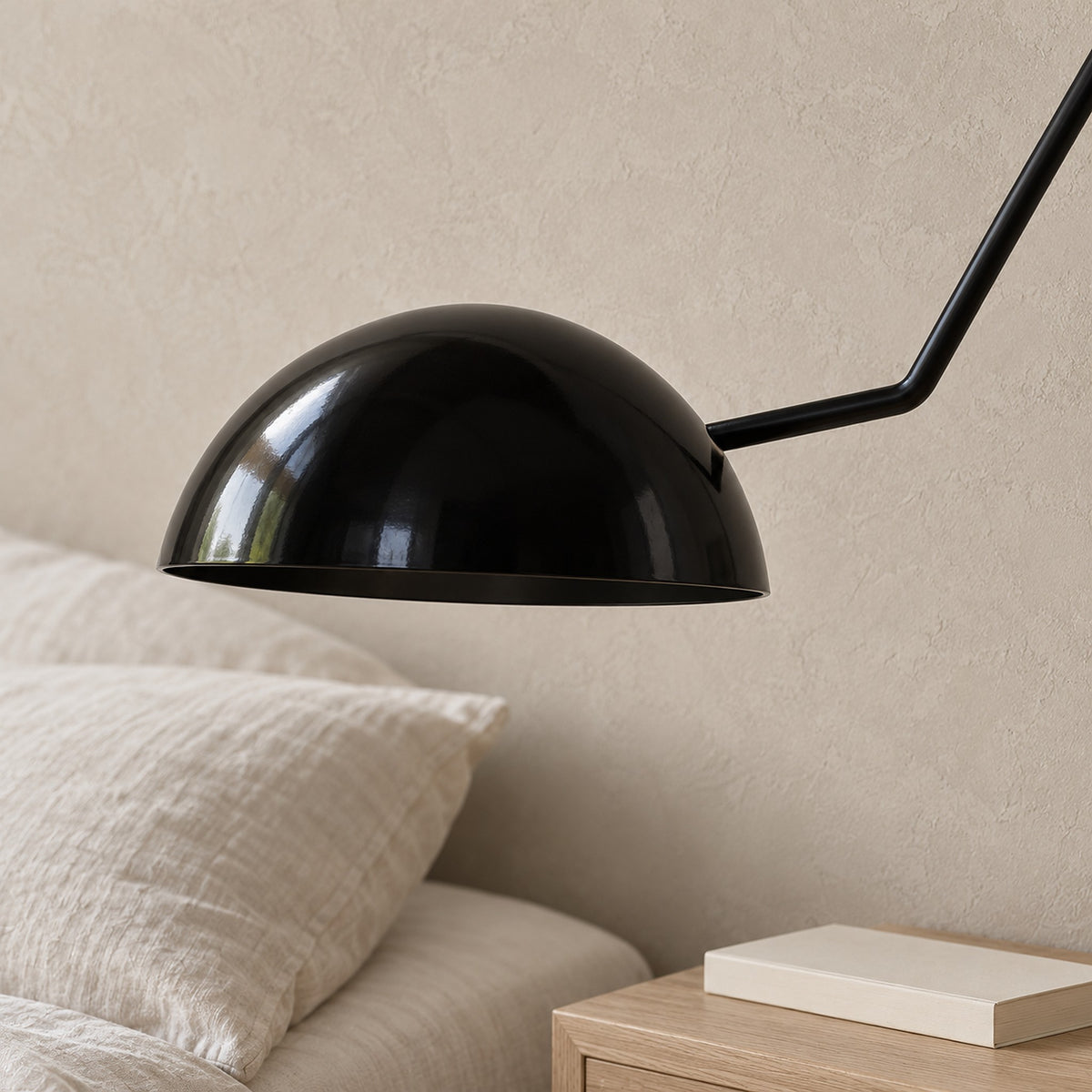 Nalesio black wall light close up of the metal dome shade and open underside in daylight