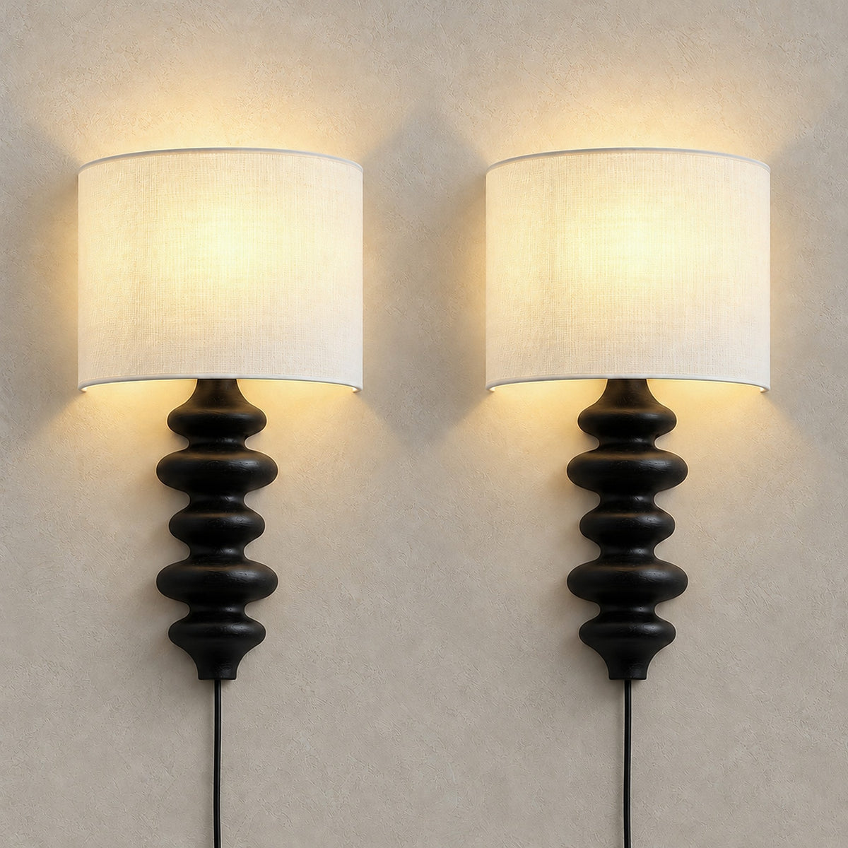 Nalimor black plug in wall lamp set of 2, both lamps lit with linen shades