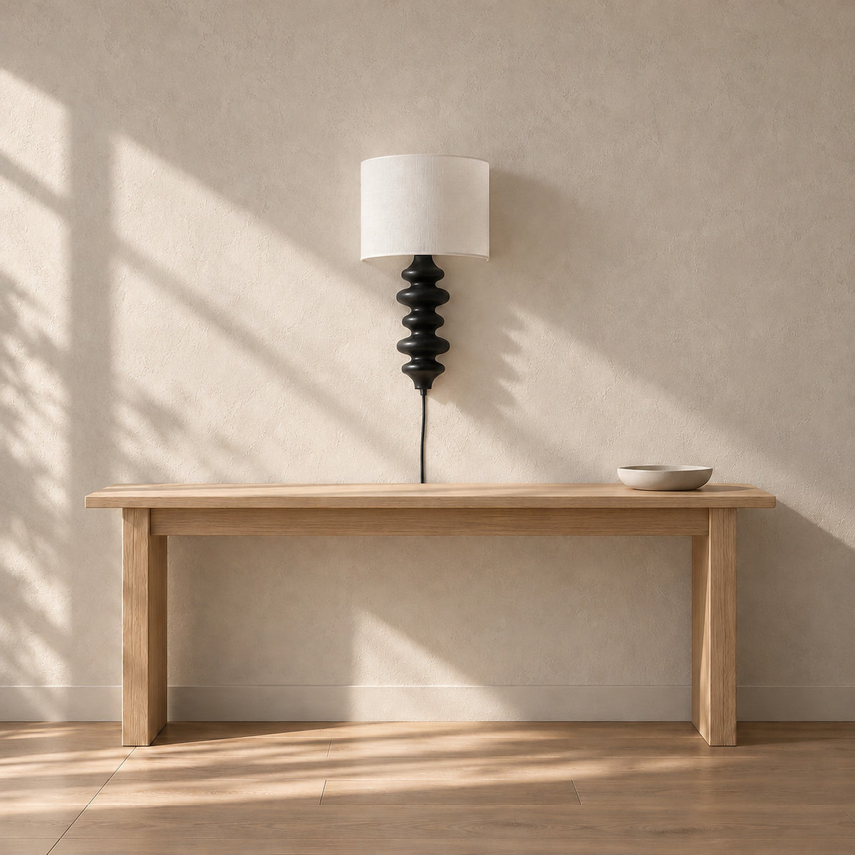 Nalimor black plug in wall light unlit above an entry console in daylight