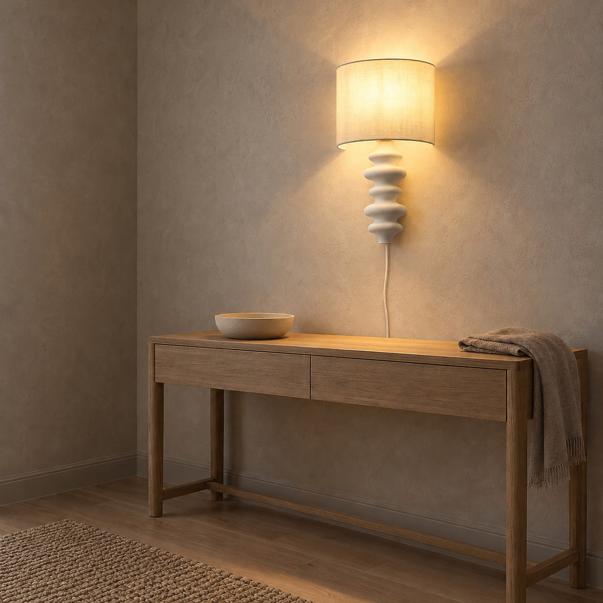 Nalimor white plug in wall light glowing above a console table in an entryway #color_white